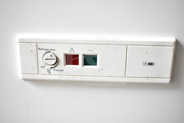 Close-up of Whirlpool WZC5116LW chest freezer control panel with temperature knob and indicator lights. Model specifications visible.
