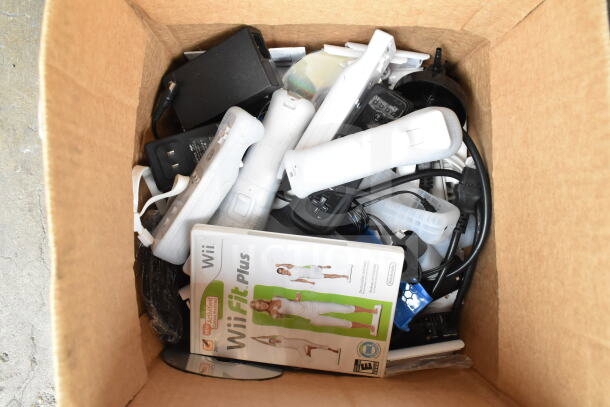 Box with Nintendo Wii items, Wii controllers, WiiFit Plus game case, WiiSports game, cables. Mixed condition.