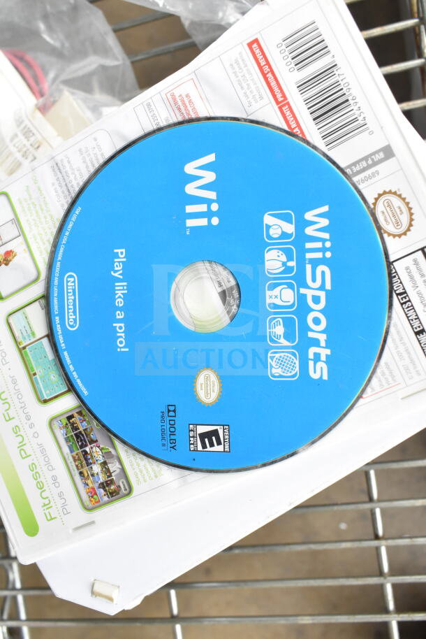 Nintendo Wii bundle with WiiSports disc, WiiFit Plus game case, various accessories. Good condition, includes manual.