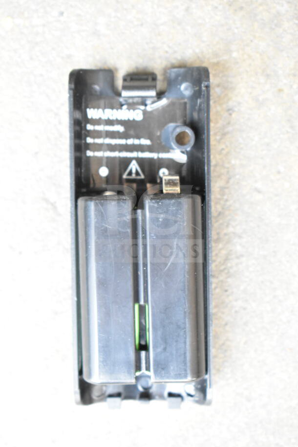 Black battery compartment with visible warning labels, part of Nintendo Wii accessories auction.