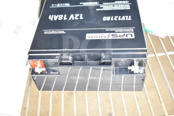 UPS TLV12180 Battery, 12V 18Ah, black casing, visible terminal connections, markings include model and specs.