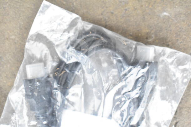 Clear poly bag containing various cords and a battery charger. Bag is slightly crinkled.