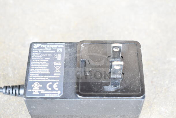 "FSP Group Inc. Sparkle Power adapter, model FSP040-DHAN2, with label details. Part of a mixed cord and charger lot."