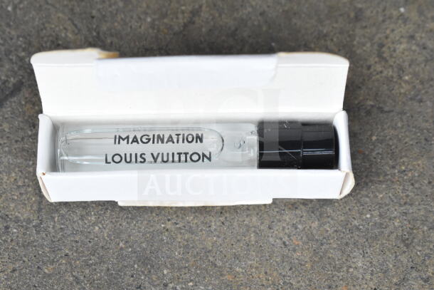 A clear poly bin containing a variety of cords and a battery charger labeled "ALL ONE MONEY!" for auction.
