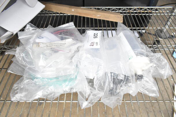 Plastic bags containing Hatco R02.19.017.00 Infinite Switch and Salter Labs hoses on a metal shelf. Markings indicate lot of 8 items.