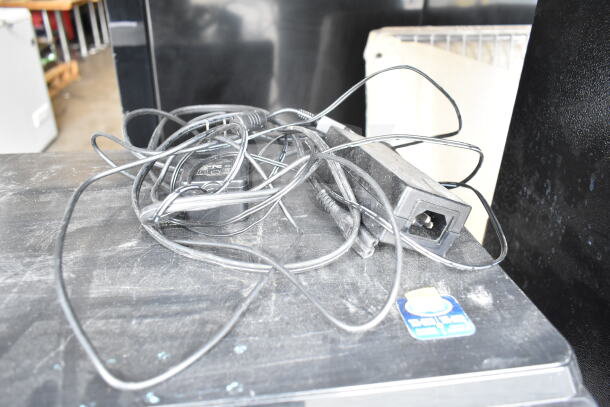 Brother HL-L2380DW printer with tangled power cords visible, in used condition. 120V, 1 Phase. Dust present.