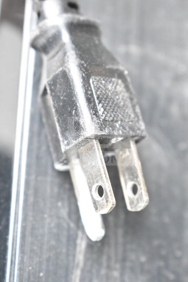 Power plug of Brother HL-L2380DW printer. 120 Volts, 1 Phase. Close-up view, showing wear.