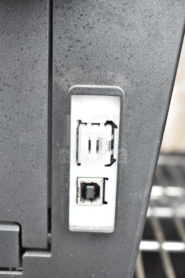 Brother HL-L2380DW printer ports detail, showing USB and connection interfaces. Black finish, countertop model.