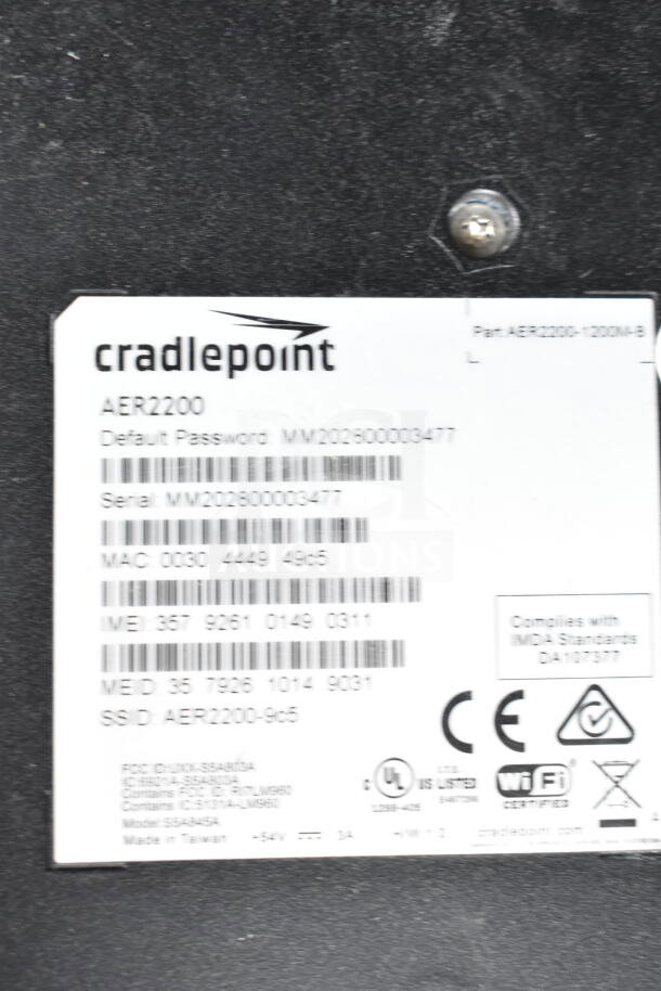 Cradlepoint AER2200 router label with serial number MM202600003477, MAC 0030 4449 4965, and various compliance symbols.