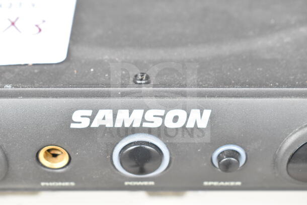 Samson Servo 120a amplifier, close-up showing headphone jack, power, and speaker buttons, slight wear visible.