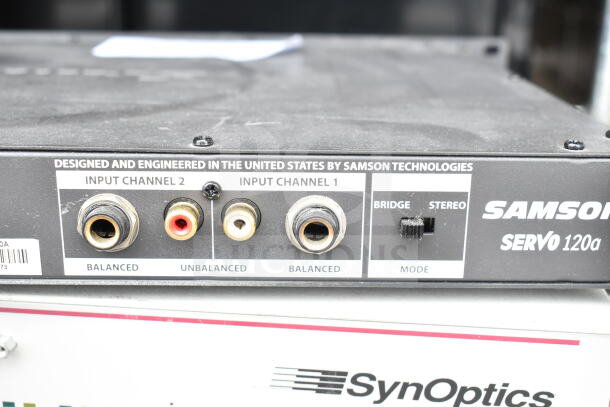 Samson Servo 120a amplifier with balanced/unbalanced inputs, SynOptics LattisHub 2814 visible; auction includes Cradlepoint AER2200.