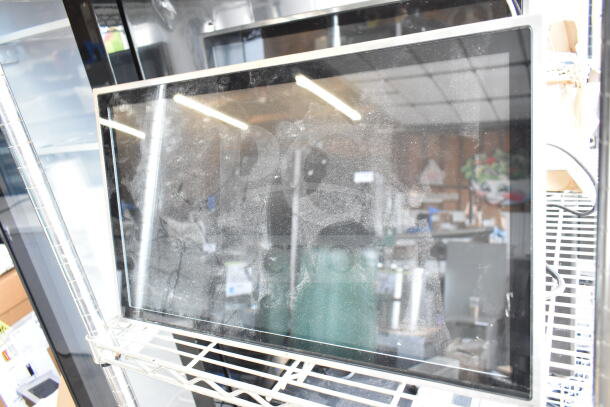Dusty POS monitor on wire shelf, part of auction lot with Epson and Dell receipt printers.