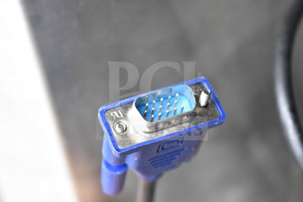 Close-up of a blue VGA connector, part of a set including POS monitors and Epson and Dell receipt printers.