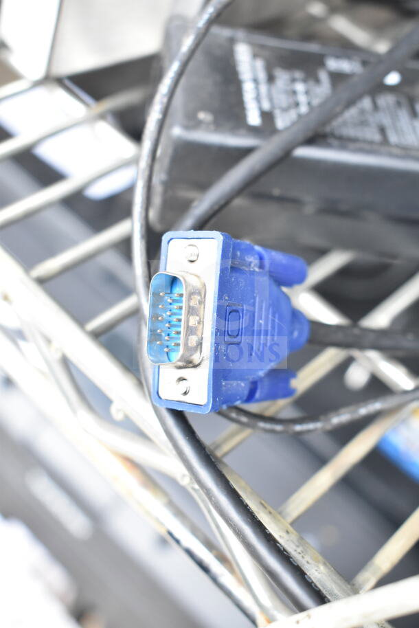 Close-up of a VGA connector and cables, part of an auction lot with POS monitors, Epson, and Dell receipt printers.