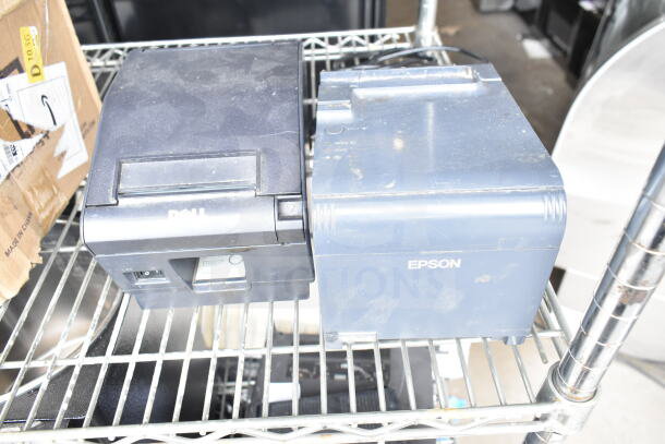 Dell and Epson receipt printers on a metal shelf, showing moderate wear, ideal for retail point-of-sale setups.