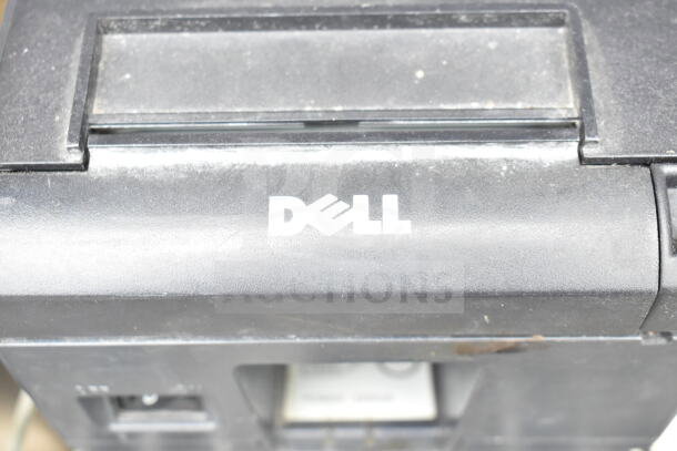 Dell receipt printer, used, black with visible wear. Included in auction with POS monitors, Epson printer. Five items total.