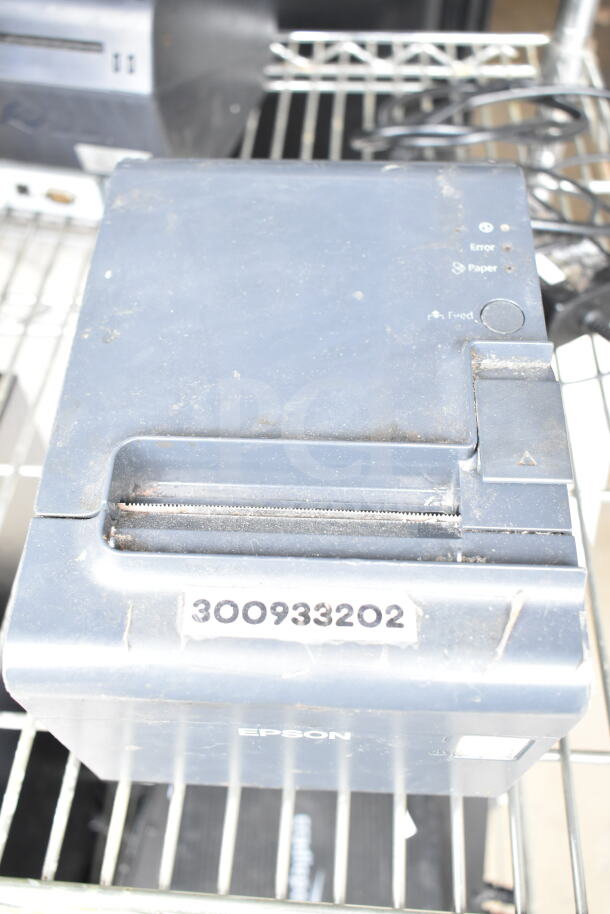 Epson receipt printer with visible wear, model number 300933202 on label. Includes error, paper, and feed indicators.