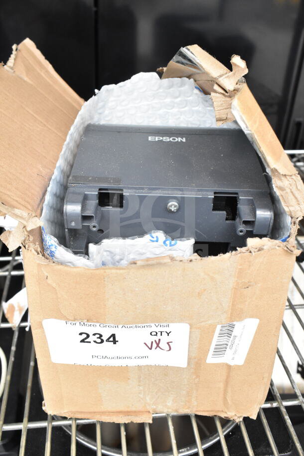 Damaged box containing Epson receipt printer, part of a lot including POS monitors and Dell printer. Label reads "QTY x5."