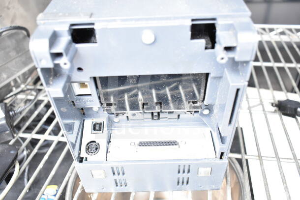 Auction item showing a grey receipt printer with visible ports and connectors in used condition.