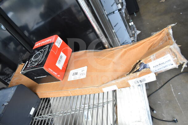 2 items: THBB1112-C throttle body box, Regency 600BDP30 beer drip tray in torn packaging, show auction labels.