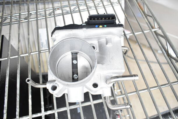 THBB1112-C throttle body on a metal rack, new condition, with connectors visible. High-performance automotive part.
