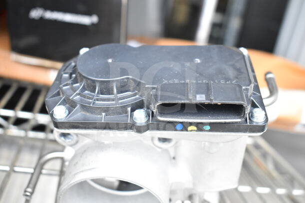 THBB1112-C throttle body with vented design and 4 mounting screws, shown on a black box background.