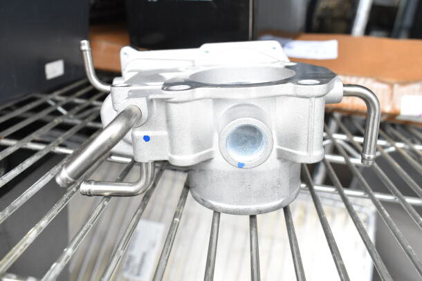 THBB1112-C Throttle Body on shelf, metallic finish, with visible ports and mounting holes, in excellent condition.