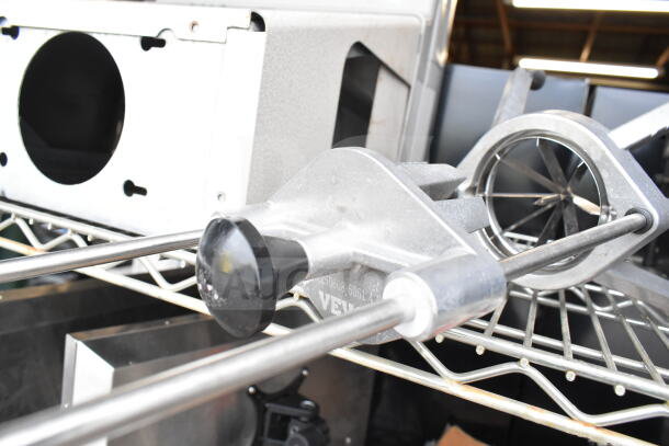 Vevor Countertop Vegetable Wedge Cutter, metal body, visible blades, light use, placed on a wire shelf.