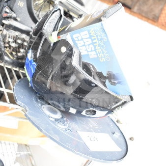 3 various items including a dash cam box, OnlyNY helmet, and Roomba on a shelf. Mixed condition.