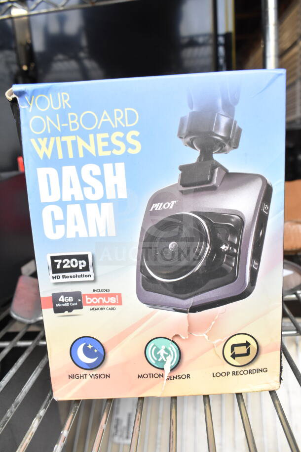 Pilot dash cam with 720p HD resolution, night vision, motion sensor, loop recording. Includes 4GB MicroSD card. Box shows wear.