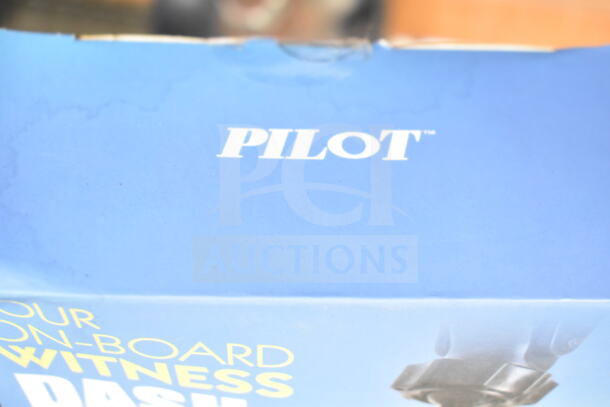 Auction items include a Pilot dash cam box cover showcasing branding. Condition and other items not visible.