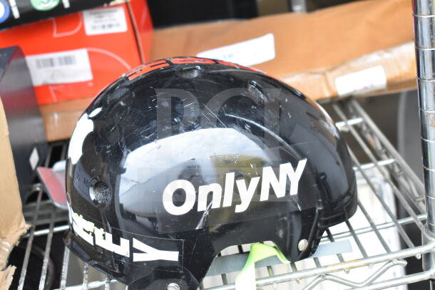 OnlyNY helmet in black, visible scratches, bold white logo. Part of auction set with dash cam and Roomba.