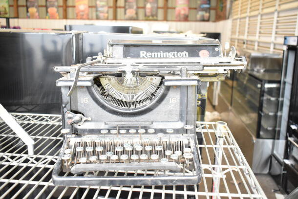 Remington countertop typewriter, vintage model 16, featuring classic keys and worn metal finish. Condition appears used.