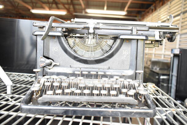 Remington Countertop Typewriter, vintage model 16, featuring exposed mechanics and classic key design, in used condition.