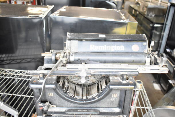 Remington countertop typewriter, vintage model, in used condition. Features visible Remington branding and typebars.