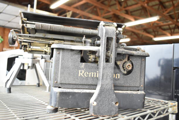 Remington Countertop Typewriter in vintage condition, featuring visible mechanisms and "Remington" label on the side.