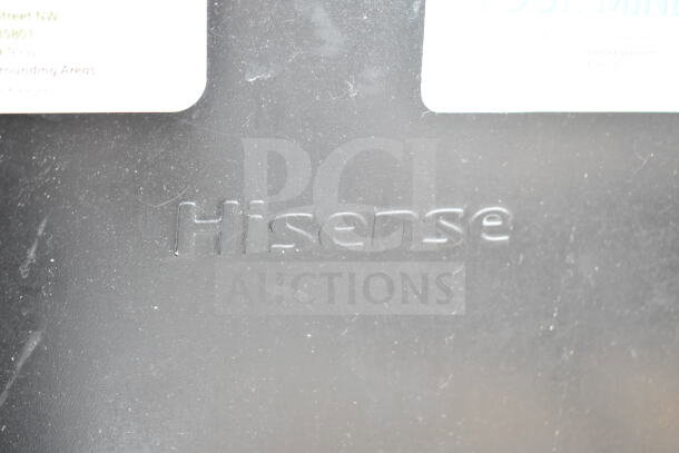 "Hisense logo on mini cooler exterior, indicating brand inclusion in auction lot of 4 coolers, 120 volts, 1 phase."