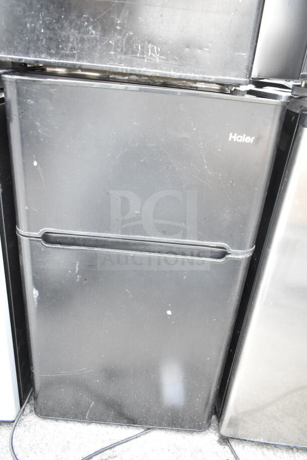 4 mini coolers including Frigidaire, Haier, Hisense, 120 volts, 1 phase. Black Haier cooler shown, in used condition.