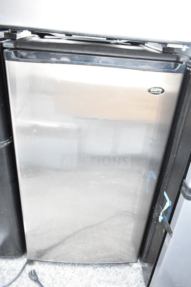 4 mini coolers including Galanz, Sanyo, EdgeStar. 120 volts, 1 phase. Stainless steel finish. Visible Sanyo logo.