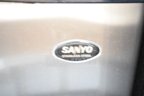 Four mini coolers by Galanz, Sanyo, EdgeStar; stainless steel, 120V, 1 phase. Sanyo cooler features visible logo.