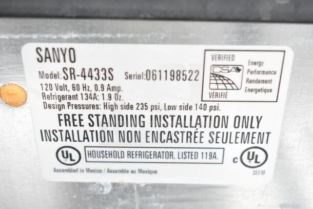 Sanyo mini cooler label, model SR-4433S, 120V, 60Hz, 0.9A, using refrigerant 134A, free-standing installation required.