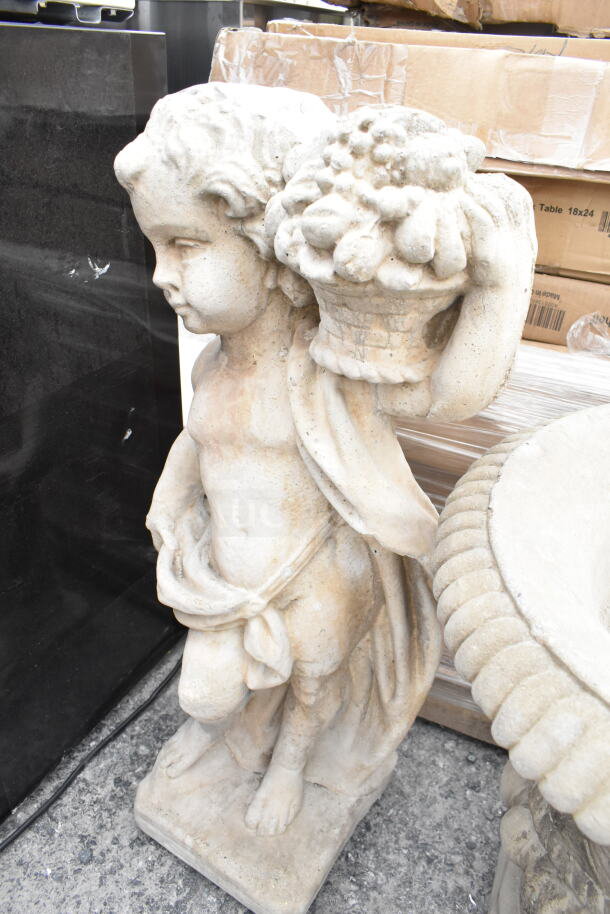 Antique stone statue of a child holding a fruit basket, detailed carving, weathered patina, suitable for garden display.