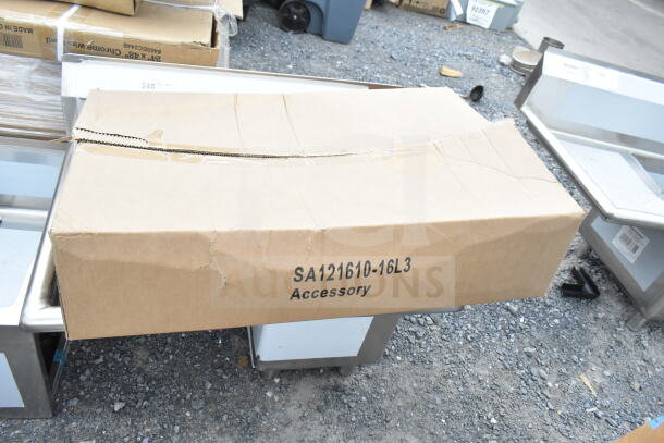 Brown cardboard box containing KoolMore SA121610-16L3 sink, brand new with minor dents, dimensions: 31 inches, includes drainboard.