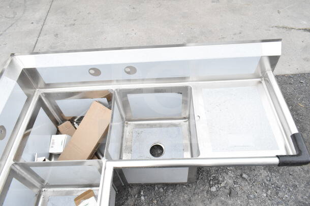 Brand new Regency 600S3181818C 57" corner sink, three compartments, two 18" drainboards, scratch and dent.