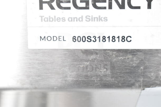 Regency 600S3181818C label on stainless steel, indicating a 57" three-compartment corner sink with two 18" drainboards.