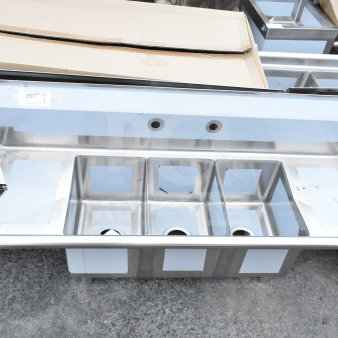 Three-compartment KoolMore SC101410-12B3 54-inch stainless steel sink, brand new with visible scratches and dents.