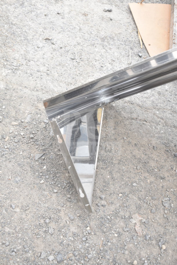 Metal wall mount shelf with mounting holes, reflective finish; ideal for home or office use, offers sturdy support.