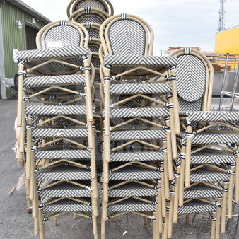 32 stackable outdoor chairs with bamboo-style frames and chevron patterned seats. Brand new, with minor scratches.