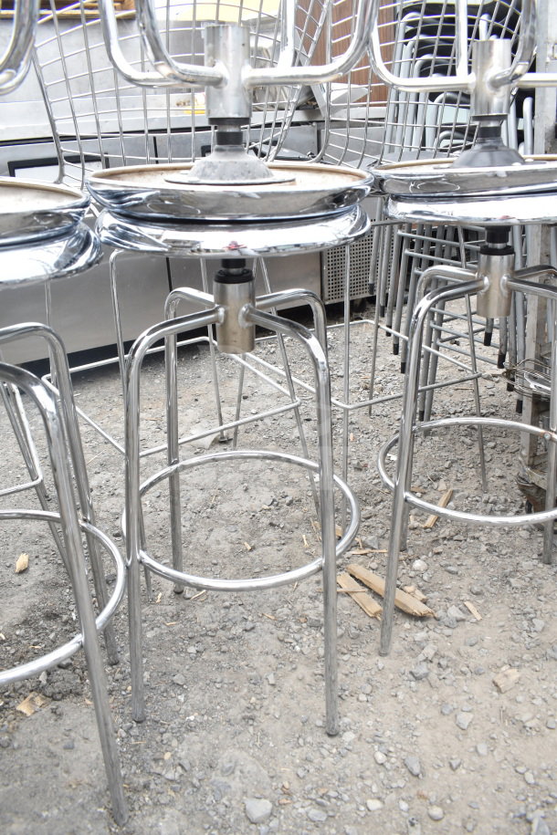 6 chrome metal stools with round bases, used condition, ideal for bar or kitchen, no visible brand markings.