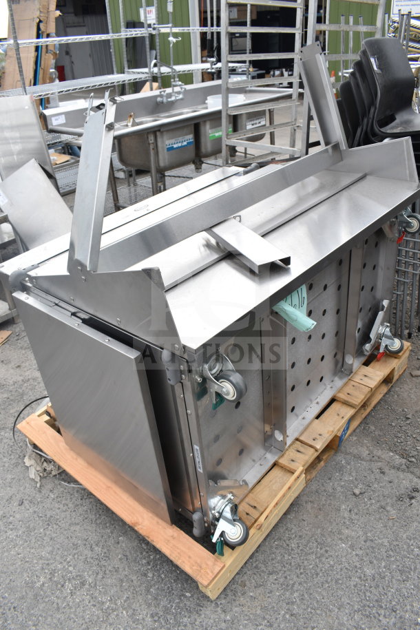 Cadco 523616 Serving Station, stainless steel, on caster wheels, visible storage compartment, condition appears gently used.
